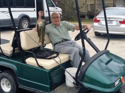 John with bass and golf cart